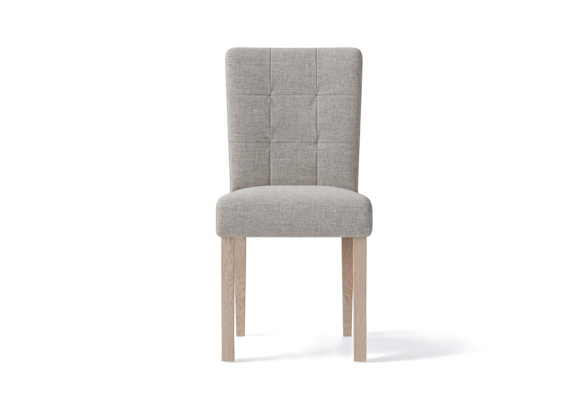 Adelina upholstered dining chair in light grey woven fabric with pale oak legs, seen from the front on a white background