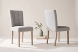 Two Adelina dining chairs in light grey woven fabric, one seen from the front and one from behind