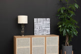 Adeline table lamp on a cane-front sideboard against a charcoal wall