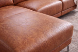Close-up of distressed cognac Italian aniline leather upholstery on the Andria chaise