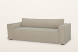 Agerola track arm sofa in Sand fabric, three-quarter view on a warm white studio backdrop: wide square arms, one long seat and one long back cushion, flange seams