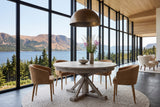 Aggius round dining table in a Bonne Bay house in Gros Morne, Newfoundland, with a glass wall to the fjord and the Tablelands