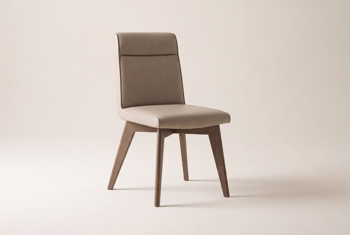 Aileen dining chair in beige leather with square, tapered ash legs on a studio backdrop, front three-quarter view