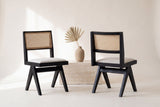 Two Alaya dining chairs, front and back views, beside a travertine block