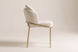 Alexander ivory fabric dining chair with brass legs in side view on an off-white studio backdrop