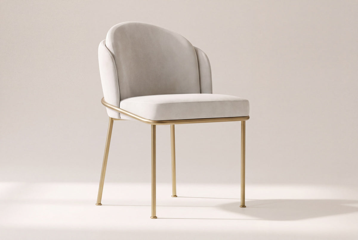Alexander ivory fabric dining chair with brass legs on an off-white studio backdrop