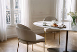 Two Alexander dining chairs at a marble breakfast table in a sunlit Paris apartment
