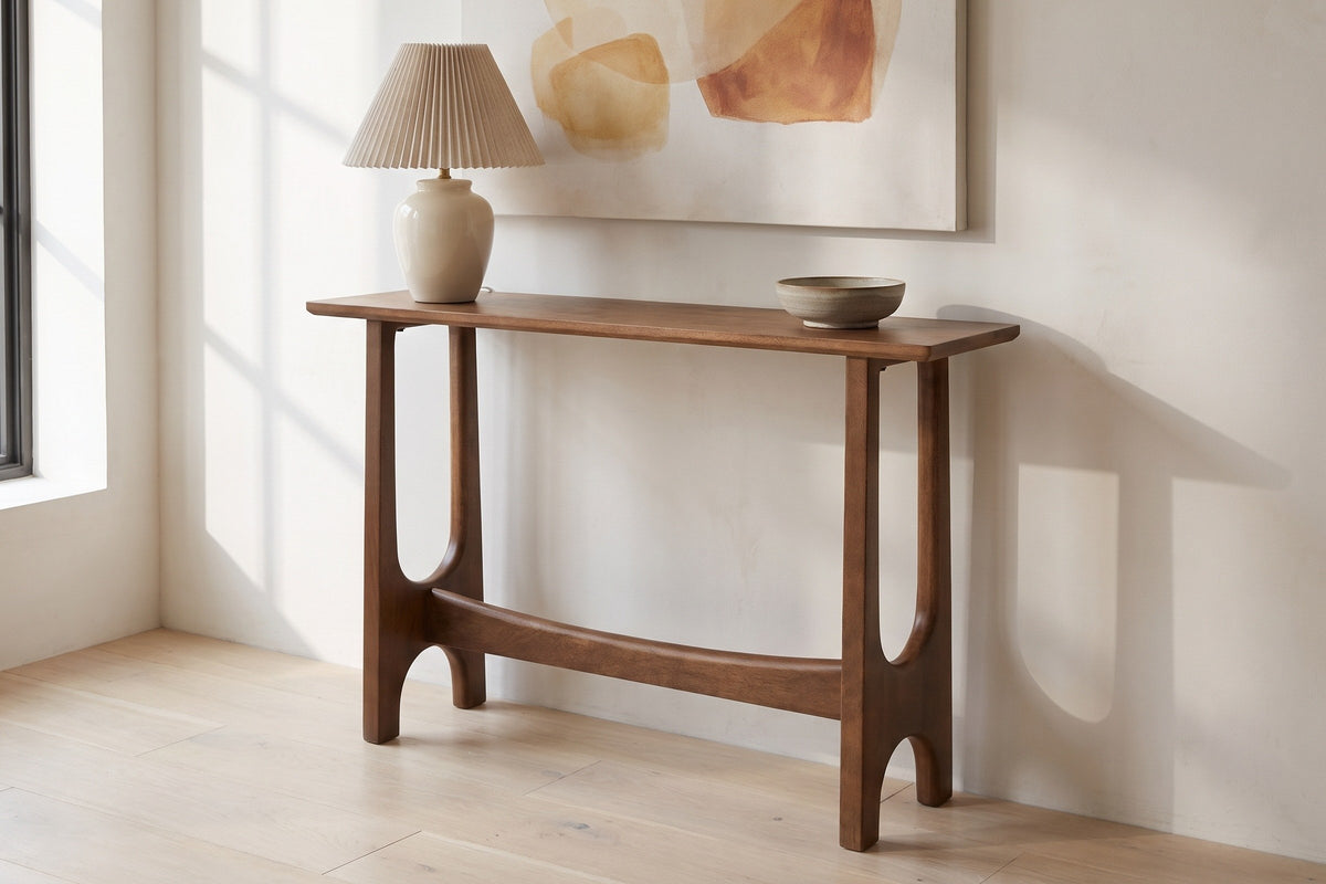 Amelia console table in walnut against a warm white plaster wall in a Montreal loft entry