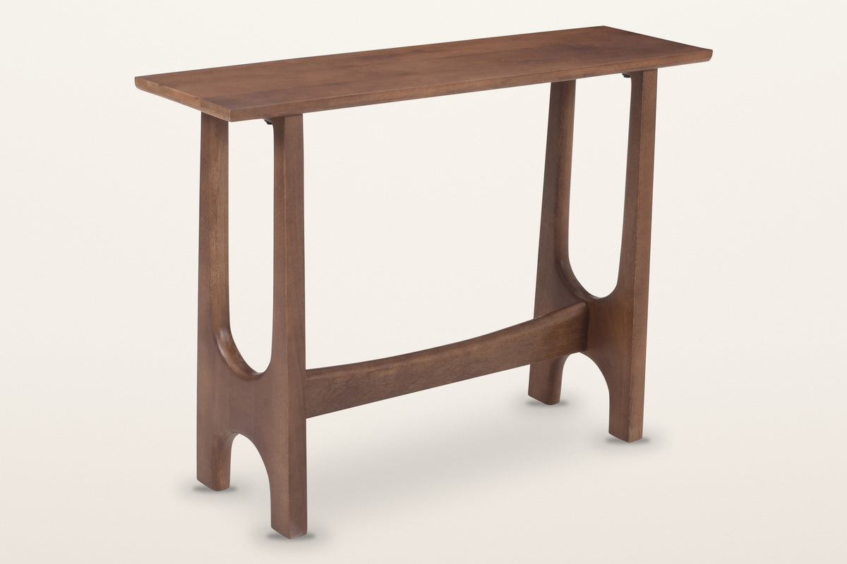 Amelia sculpted mango wood console table in walnut, three-quarter view on a warm white studio backdrop