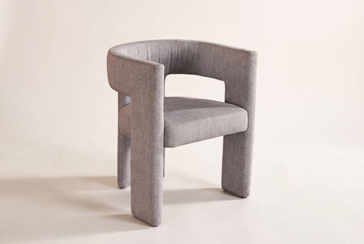 Andrea light grey fabric dining chair on an off-white studio backdrop