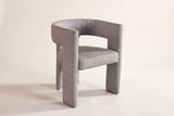 Andrea light grey fabric dining chair on an off-white studio backdrop