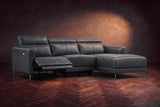 The Andria power reclining sectional on a walnut herringbone floor with the arm-end power recliner open: its two-tier footrest out and its headrest raised. Shown in Aged Slate, Right chaise.