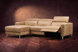 The Andria power reclining sectional on a walnut herringbone floor with the arm-end power recliner open: its two-tier footrest out and its headrest raised. Shown in Washed Sand, Left chaise.