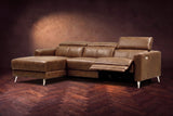 The Andria power reclining sectional on a walnut herringbone floor with the arm-end power recliner open: its two-tier footrest out and its headrest raised. Shown in Weathered Saddle, Left chaise.