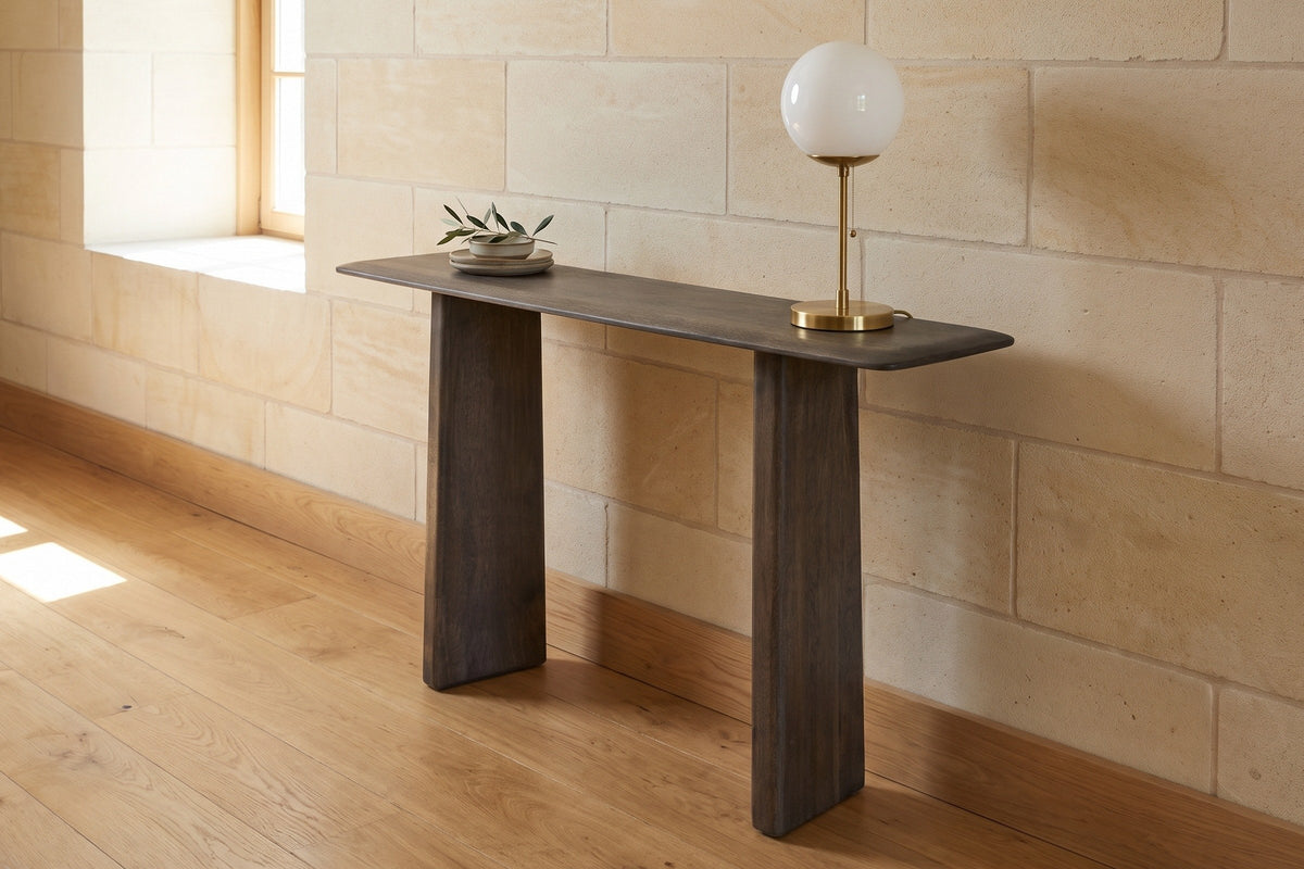 Anghiari console table in mocha against a pale limestone wall in a sunlit Quebec City hallway