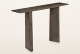 Anghiari slab leg console table in mocha, three-quarter view on a warm white studio backdrop