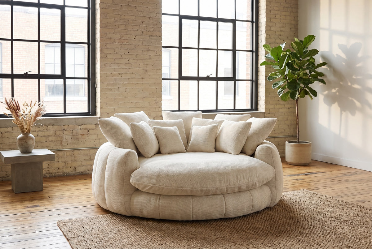 Aosta lounge chair on a jute rug in a Montreal loft with pale brick walls and steel factory windows