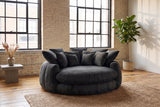 Aosta lounge chair on a jute rug in a Montreal loft with pale brick walls and steel factory windows (Black)