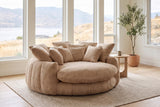 Aosta lounge chair in a Kelowna lake-house living room in the morning, the lake and dry hills beyond the windows (Coffee)