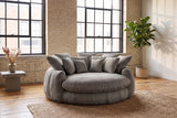 Aosta lounge chair on a jute rug in a Montreal loft with pale brick walls and steel factory windows (Grey)