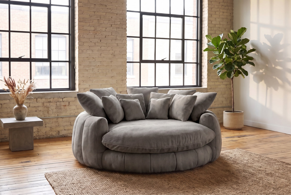 Aosta lounge chair on a jute rug in a Montreal loft with pale brick walls and steel factory windows (Grey)