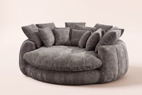Aosta oversized round lounge chair in grey chenille, three-quarter view on a warm cream studio backdrop