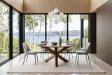 Apecchio round dining table in a Charlevoix house above the St. Lawrence, with smoked-oak panelling