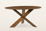 Apecchio dining table in walnut and teak, front view on a warm white studio backdrop: the three legs crossing in one knot