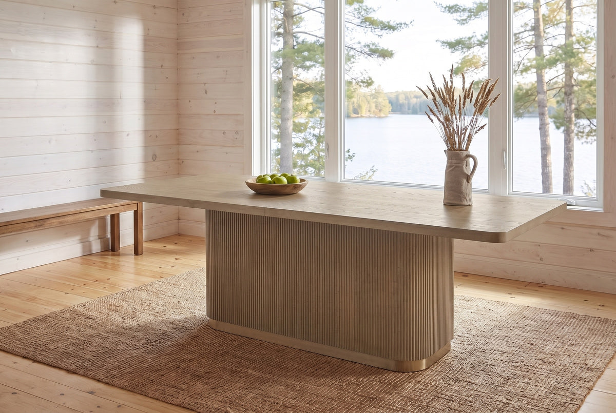 Aquileia dining table in Natural in a whitewashed Muskoka cottage dining room with a window onto the lake