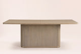 Aquileia dining table in Natural, straight front view: one fluted pedestal with rounded corners