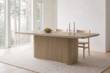 Aquileia dining table in Natural in a bright Vancouver dining room on a foggy morning, a bowl of pears and two candles on top
