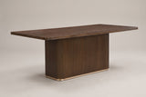 Aquileia 84-inch fluted pedestal dining table in Walnut, three-quarter view on a warm grey studio backdrop