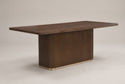 Aquileia 84-inch fluted pedestal dining table in Walnut, three-quarter view on a warm grey studio backdrop