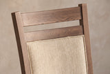Close-up of the two walnut-finish rails and the top of the padded back panel of the Arden chair