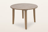 Arden round drop-leaf dining table in Walnut, both leaves up, three-quarter view on a warm white studio backdrop: a 42 in round oak-veneer top on four square splayed legs