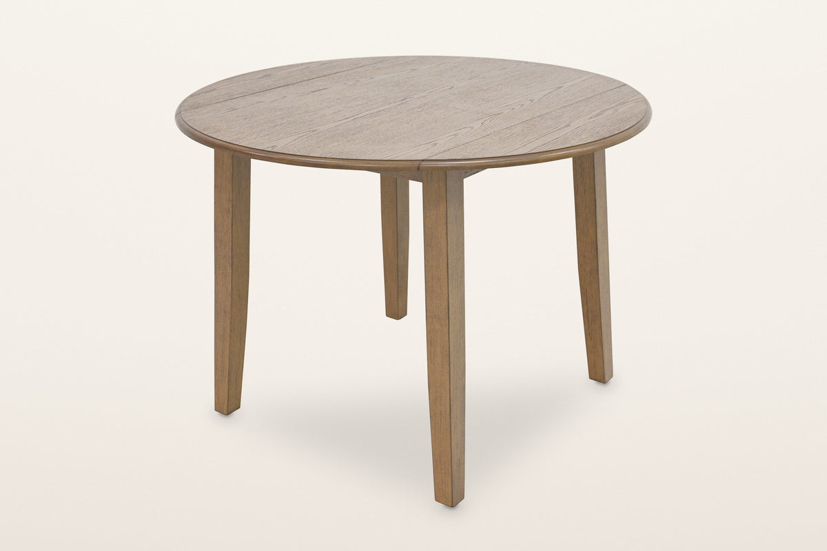Arden round drop-leaf dining table in Walnut, both leaves up, three-quarter view on a warm white studio backdrop: a 42 in round oak-veneer top on four square splayed legs