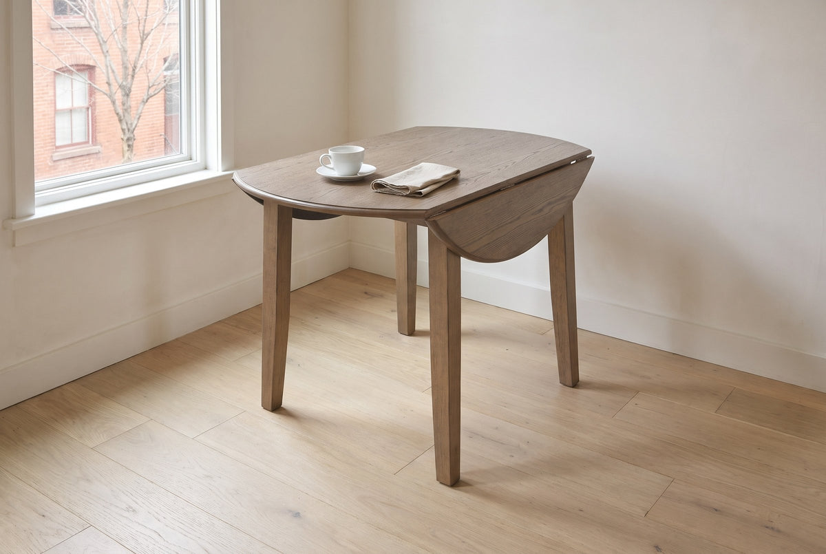 Arden drop-leaf dining table in Walnut with both leaves down, by the wall of a Cabbagetown row house in Toronto, a coffee cup on the top