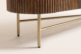 Close-up of the Arpino base: two slim aged gold legs under the reeded end, each joined by a rod in a T