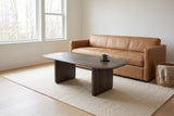 Arquata coffee table in mocha in front of a tan leather sofa in a Mount Royal, Calgary living room, aspens through the window