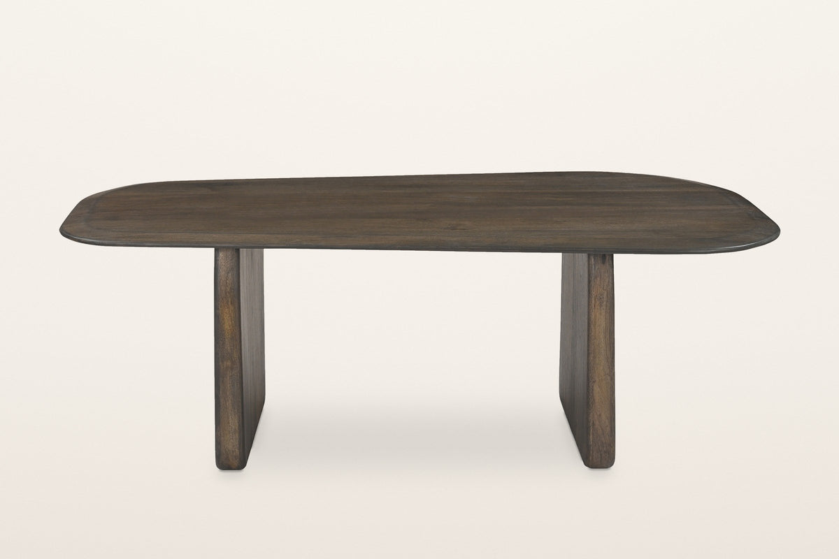 Arquata coffee table in mocha seen from the long side: a soft rounded top on two slab legs