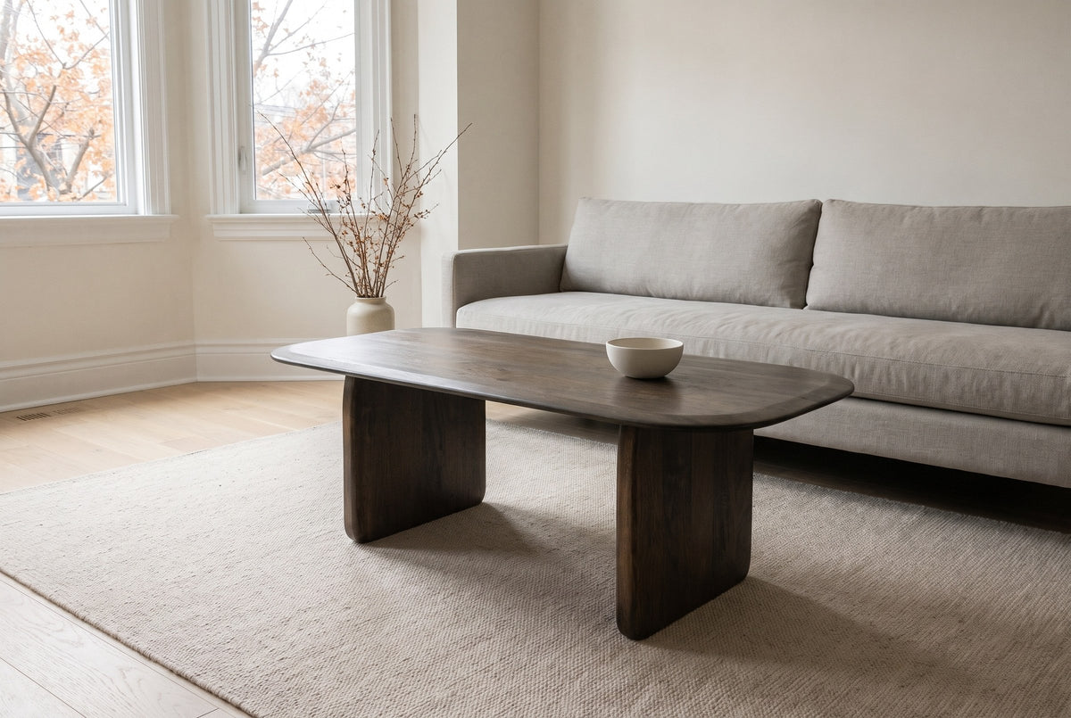 Arquata coffee table in mocha in front of a stone-grey linen sofa in a bright Rosedale, Toronto living room, a small white bowl on the top