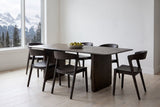 Arquata 7-piece dining set in mocha in a Canmore mountain-home dining room, snowy Rocky Mountain peaks through a tall window, a bowl of pears on the table