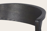 Close-up of a Certosa chair in mocha: the curved back band of ash veneer rolling round the top of the rear leg