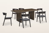 Arquata 7-piece dining set in mocha, three-quarter view on a warm white studio backdrop: the slab-leg mango wood table with six curved-back wood chairs