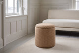 An Arvier pouf in Camel on a cream rug in a panelled Victorian living room in the South End of Halifax, a white boucle sofa behind