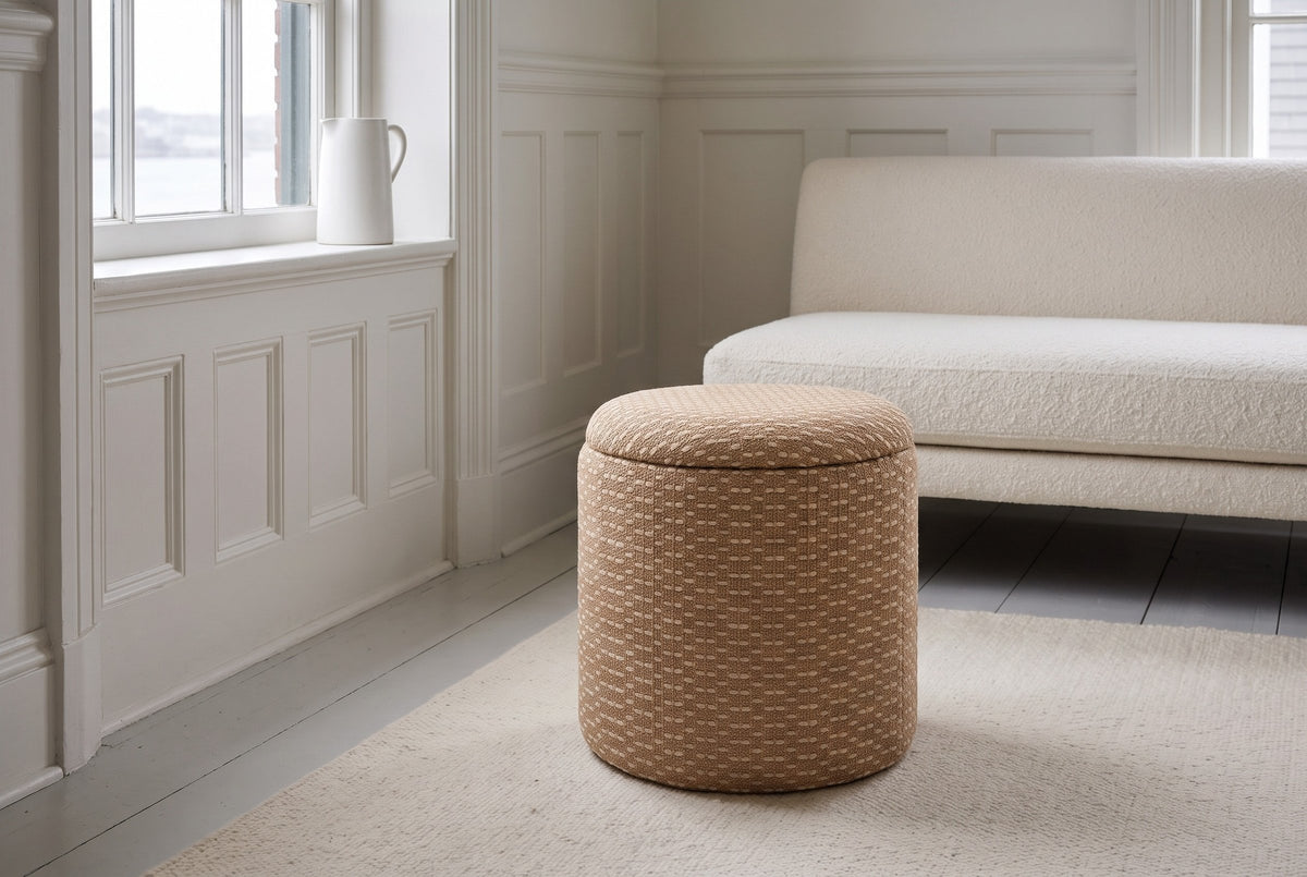 An Arvier pouf in Camel on a cream rug in a panelled Victorian living room in the South End of Halifax, a white boucle sofa behind