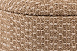 Close-up of the Arvier pouf in Camel: the padded lid's rounded edge sitting on the woven drum