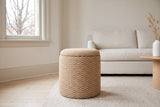 An Arvier pouf in Camel on an oatmeal wool rug in an Edwardian living room in the Glebe, Ottawa, an ivory linen sofa behind and a bare maple through the sash window