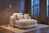 Asolo chaise lounge in Beige chenille in a panelled Toronto living room at dusk beside a brass floor lamp