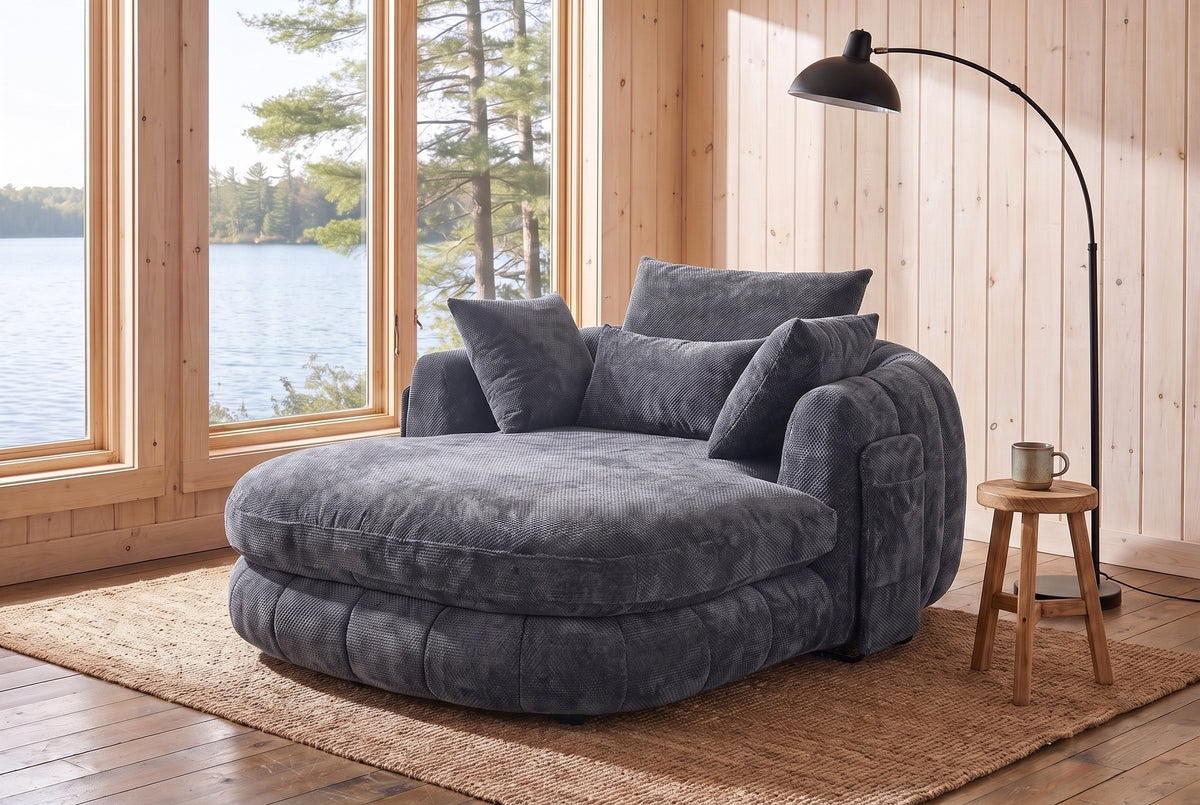 Asolo chaise lounge in Grey chenille in the reading corner of a Muskoka cottage, by a window onto the lake